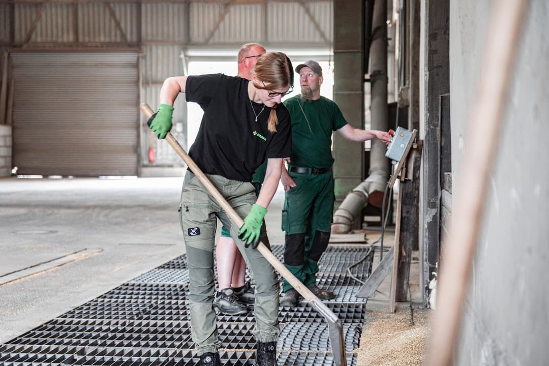 A woman working at a grain delivery silo.
